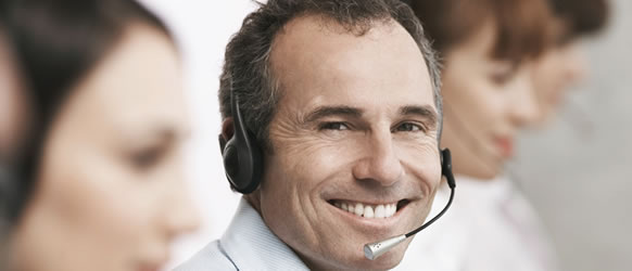 a smiling man wearing a headset