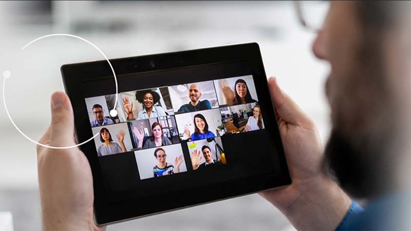Photo of a person in a virtual meeting on a tablet