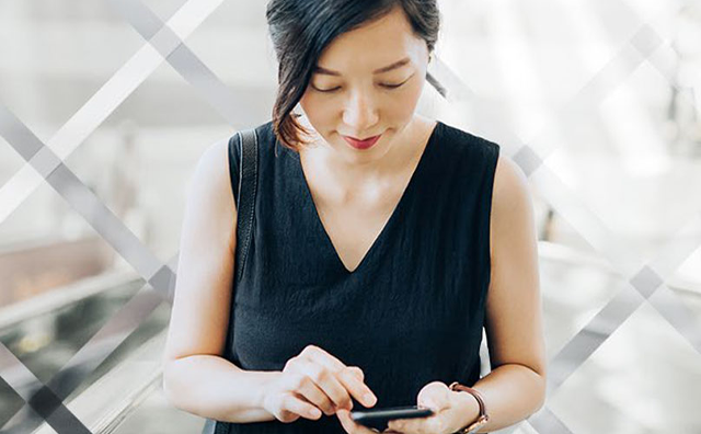 Lady using a smartphone with morphed background