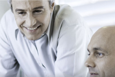 Two men looking at a computer screen