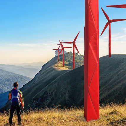 man looking at origami wind turbines