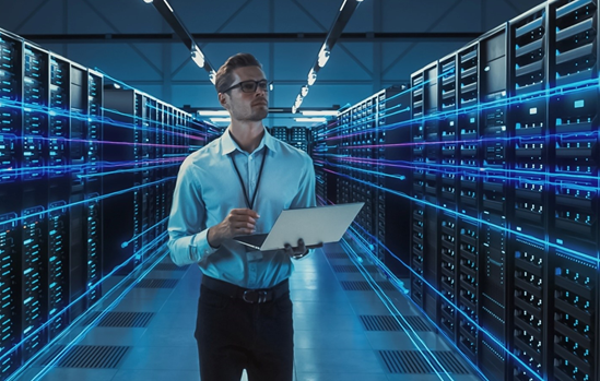 Technician holding a tablet walking between rows of server racks in a data center with digital blue light effects