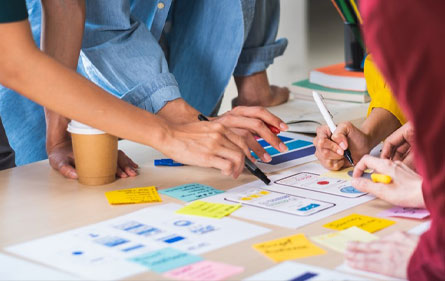 People creative working on a desk with Postit Notes