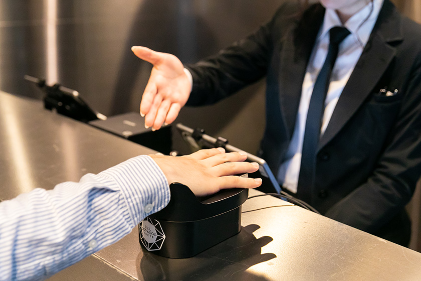 Photo : An authentication device at the reception counter. Audience members can enter the building merely by placing the palm of his or her right hand over the device without showing ID.