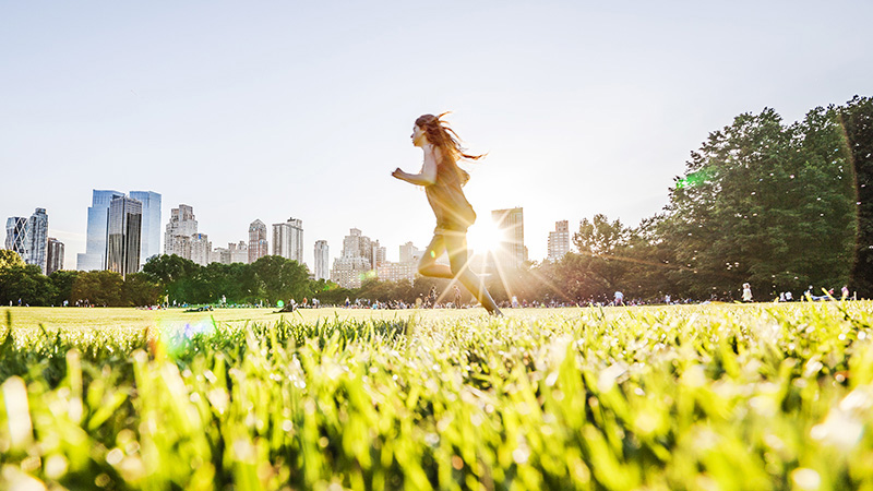 Person running through a city park