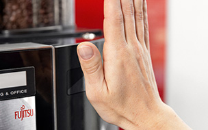 Photo of a hand in front of a PalmSecure palm vein scanner. 