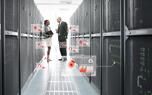 Photo of two people in a Fujitsu data centre with an overlay of red data icons