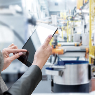 Person using a tablet in a factory - Supply Chain