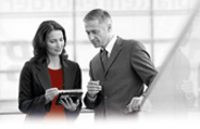 Man and a women discussing the content on a tablet that the women is holding