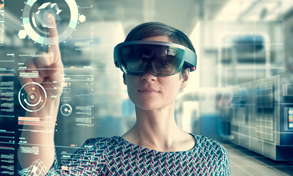 Woman touching a transparent screen while wearing an extended reality (XR) headset