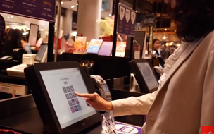 Woman using a self service checkout - SIAM case study