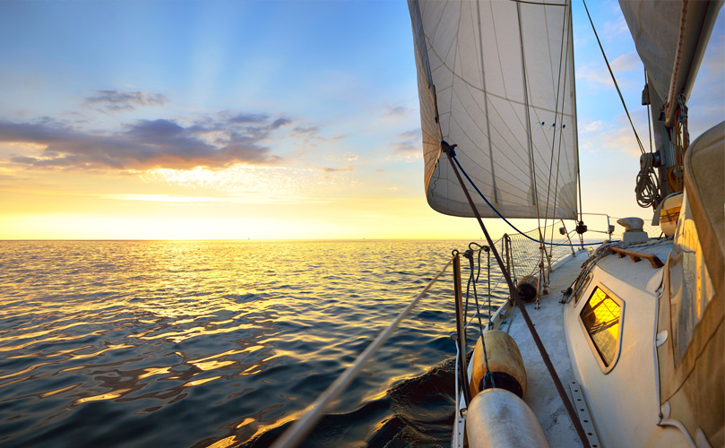 A view from the deck of a yacht sailing in calm waters
