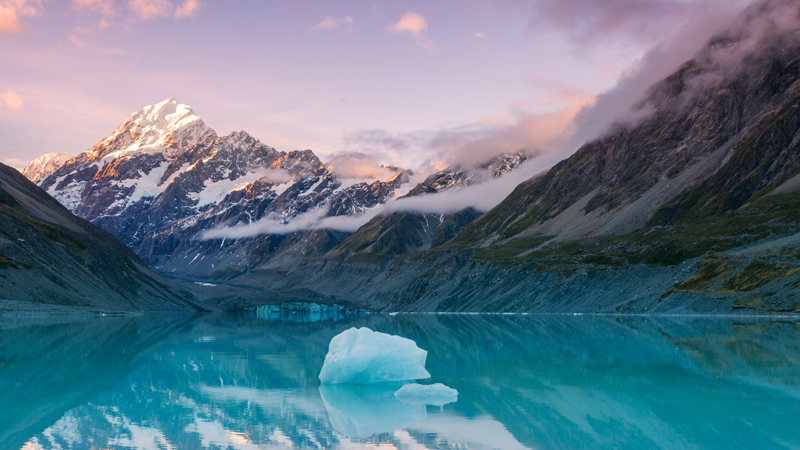 a mountain lake with iceberg in the water