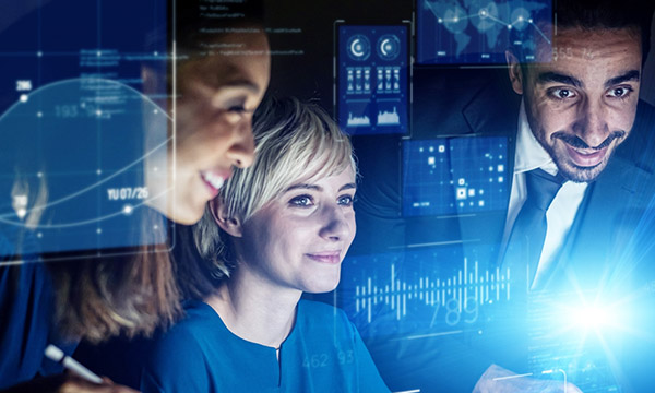 People looking at a digital screen representing collaboration between people and technology.