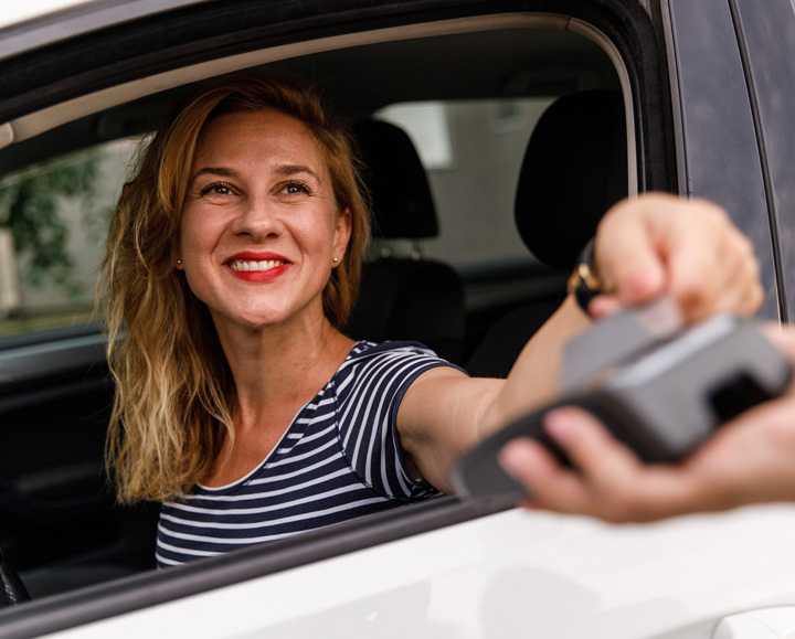 a lady checking out by tapping her credit card