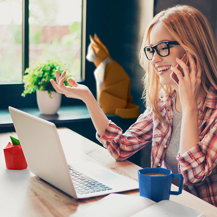 woman working from home talking on phone looking at laptop