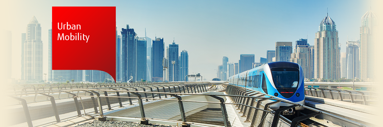 Photo of automated metro train with Dubai city in the background