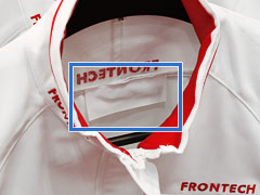 Soft RFID-UHF laundry tag used in uniform (highlighted by a blue rectangle).