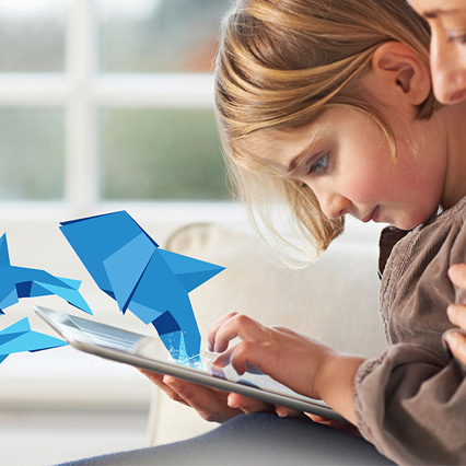 Girl using tablet with dolphin origami