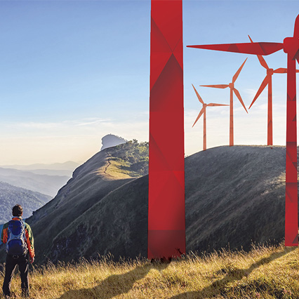 Man looking out at a hill with origami wind turbines