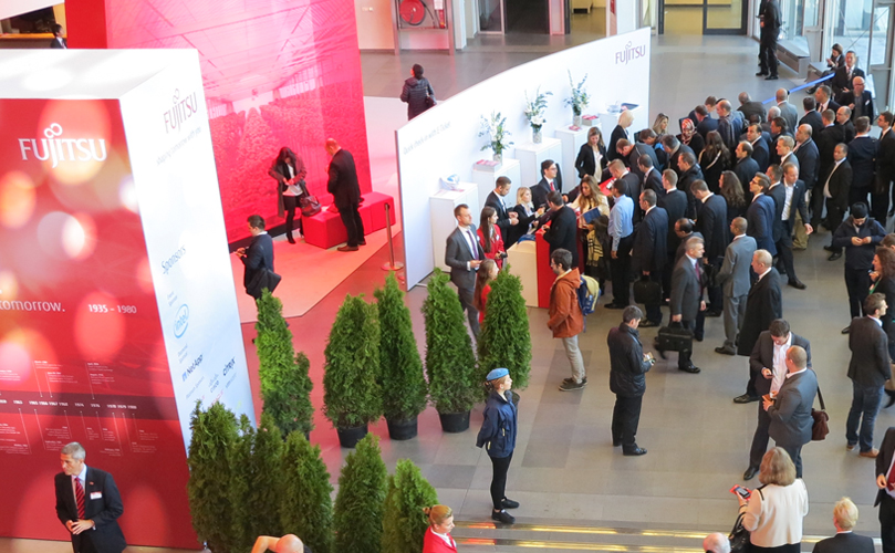 people standing at the fujitsu booth at an event
