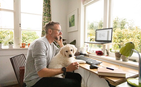 man working from home with dog