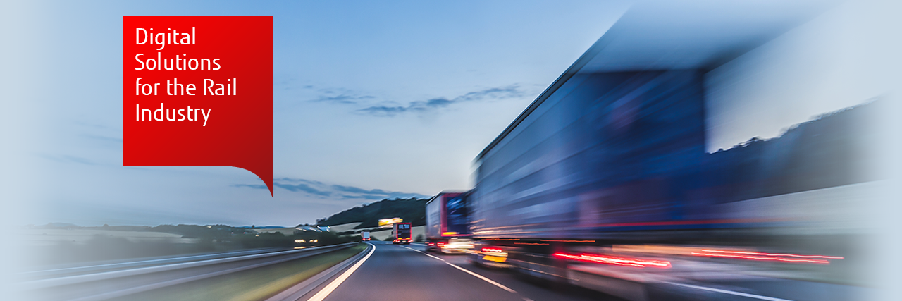 Motion-blurred photo of a line of lorries on a road at dusk