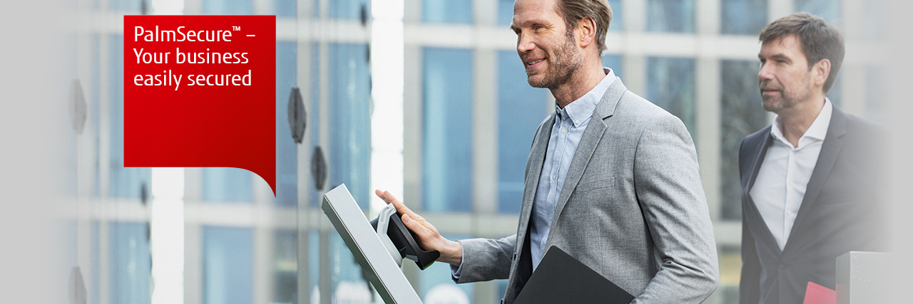 Palmsecure. Your business, easily secured. Photo of two business men accessing a building using a Palmsecure scanner. 