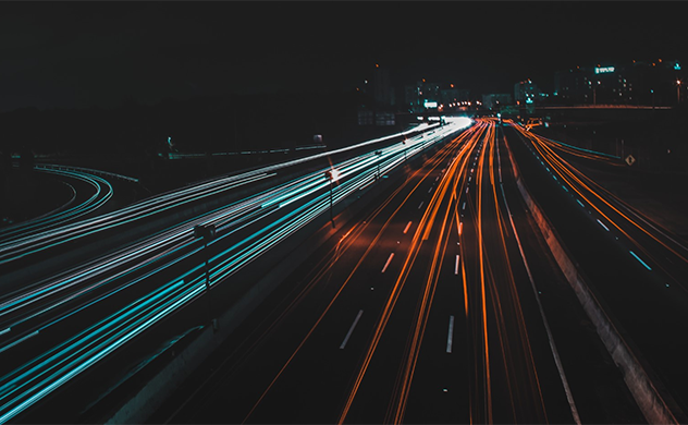 Motion-blur photo of car lights on a road at night