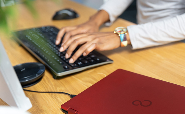 Red laptop, working at home