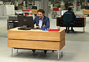 Man sitting at desk working on Fujitsu PC