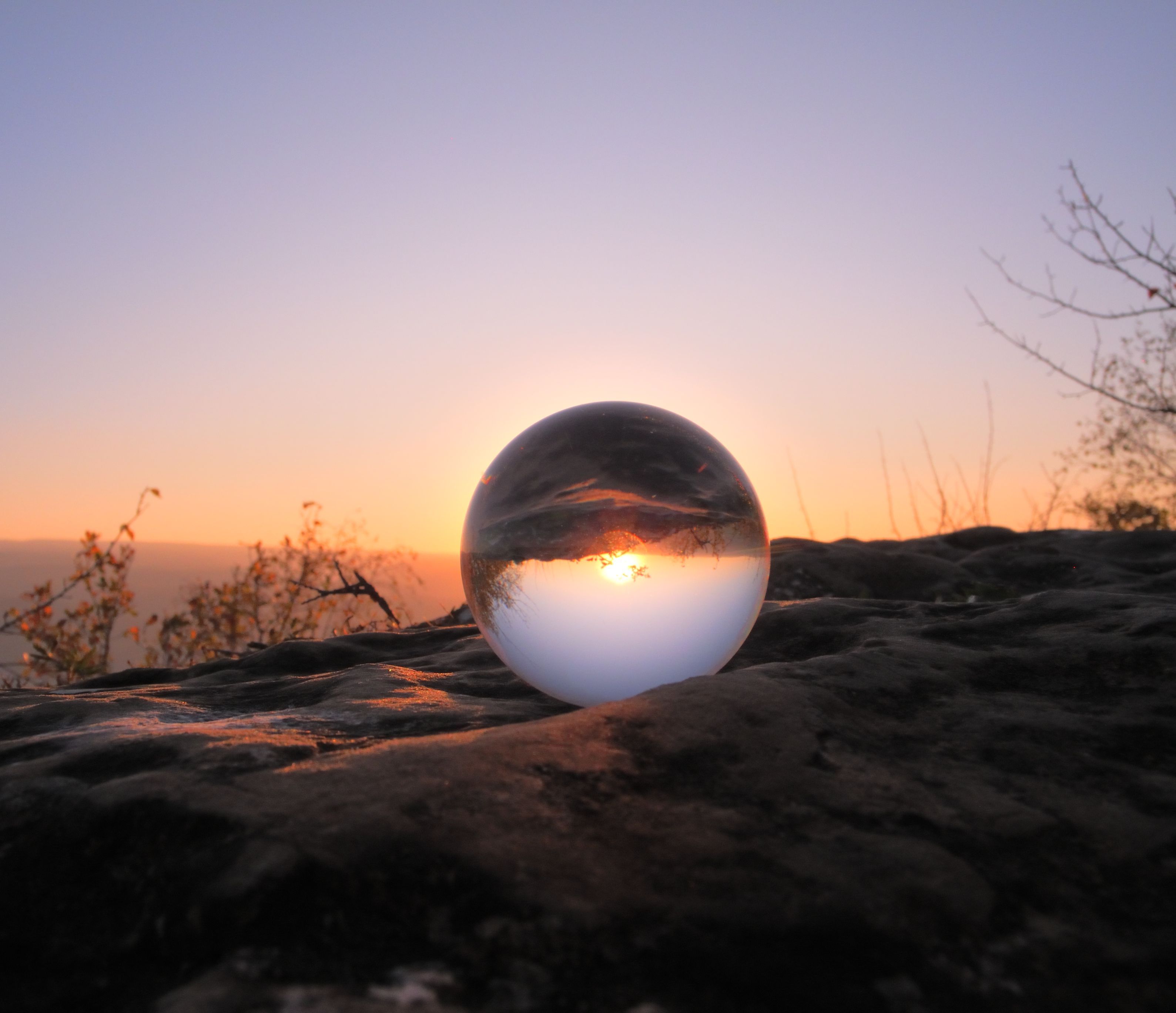 glass ball mirroring sunset