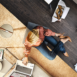 Split-screen photo of a woman trying shoes on while using a laptop