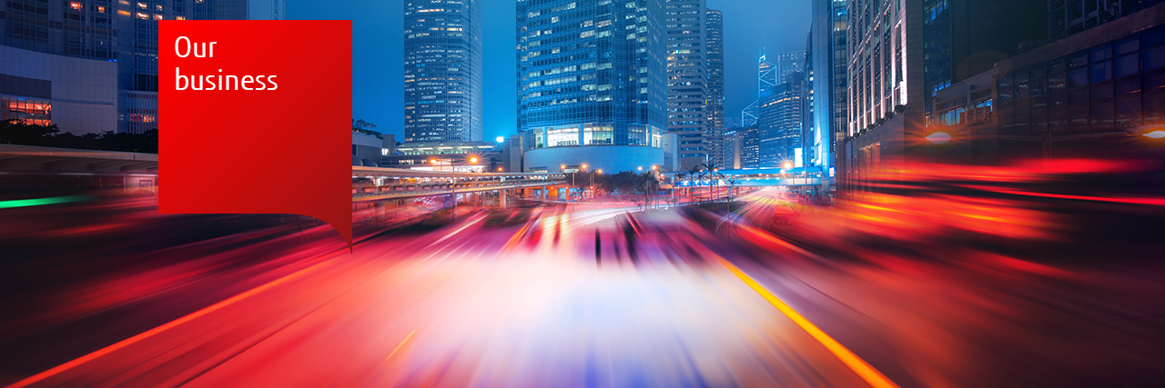 Our Business - motion blur photo of lights in front of city buildings