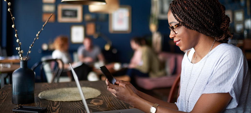 Person in cafe using phone