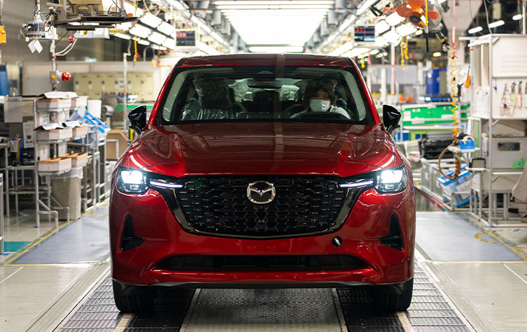 A car from the brand 'Mazda' parked inside a factory