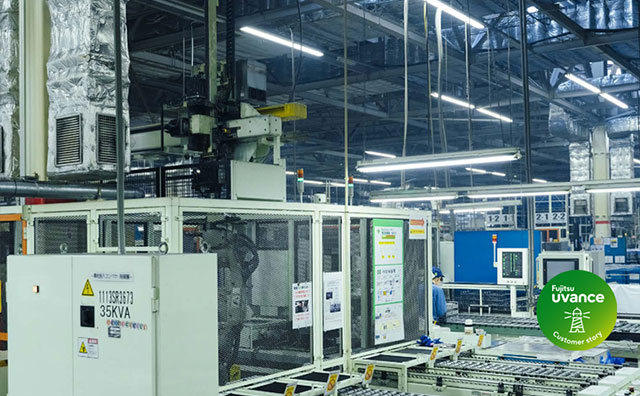 A wide-angle view of a factory interior, with a worker performing their tasks