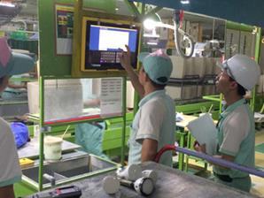 Employee inputting inspection in formation on table