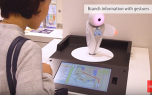 Woman looking at small robot - Taiwan FamilyMart case study